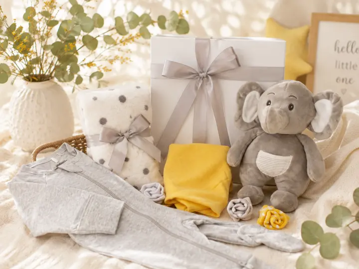 Baby hamper with a plush elephant and soft newborn clothing